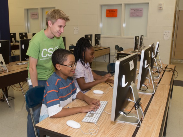 teacher and two kids on the computer